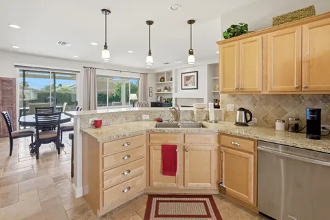 a kitchen with stainless steel appliances granite countertop a sink and cabinets