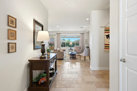 a living room with furniture a window and a painting on the wall