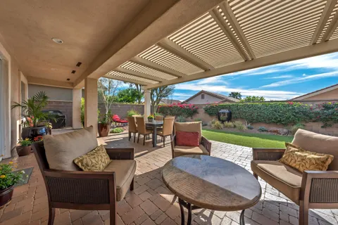a outdoor space with patio the couches and dining table with garden view