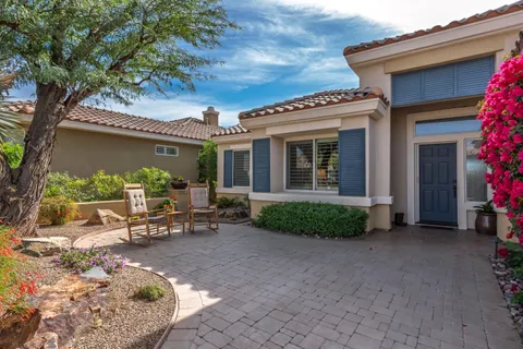 a view of a house with backyard sitting area and garden