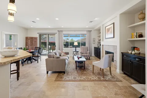 a living room with fireplace furniture and a table