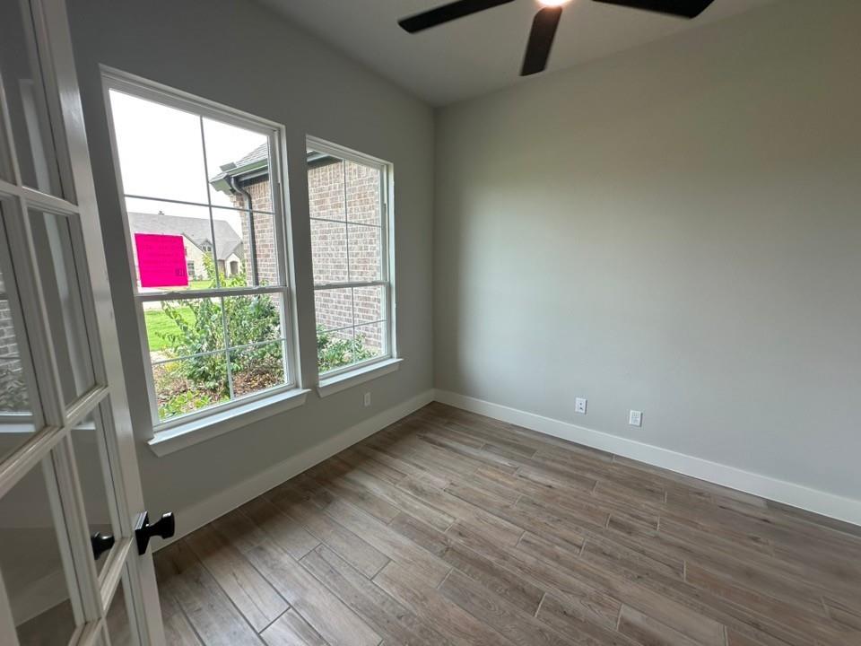 390 Cobb Road Leonard, TX 75452 - Photo 6 of 26 Room featuring wood-look tile flooring, light grey walls, and a ceiling fan