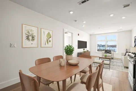a kitchen with stainless steel appliances granite countertop a stove a microwave and a white cabinets