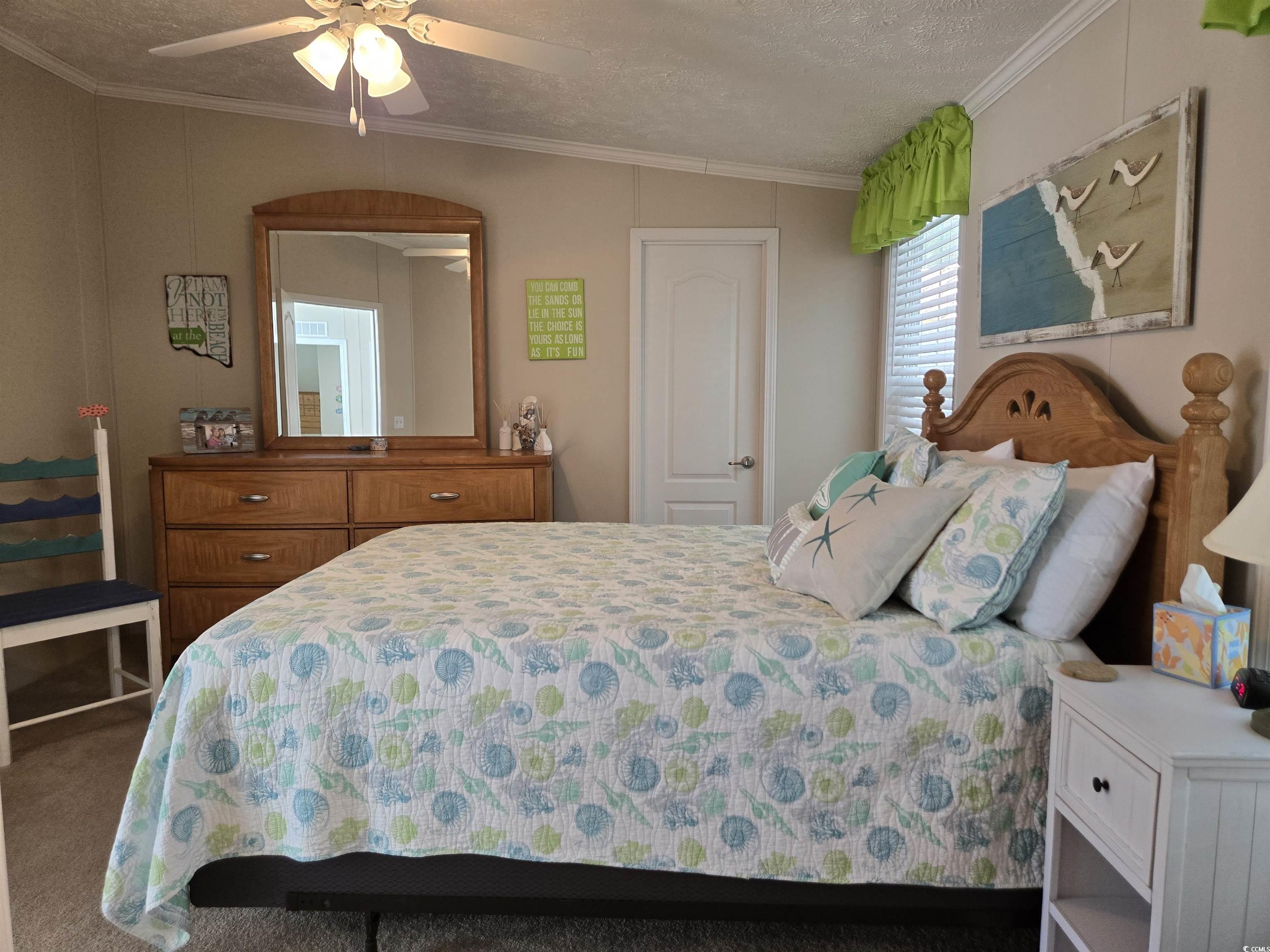 337 Clam Shell Circle Murrells Inlet, SC 29576 - Photo 19 of 29 Bedroom featuring carpet floors, a textured ceiling, ornamental molding, and ceiling fan