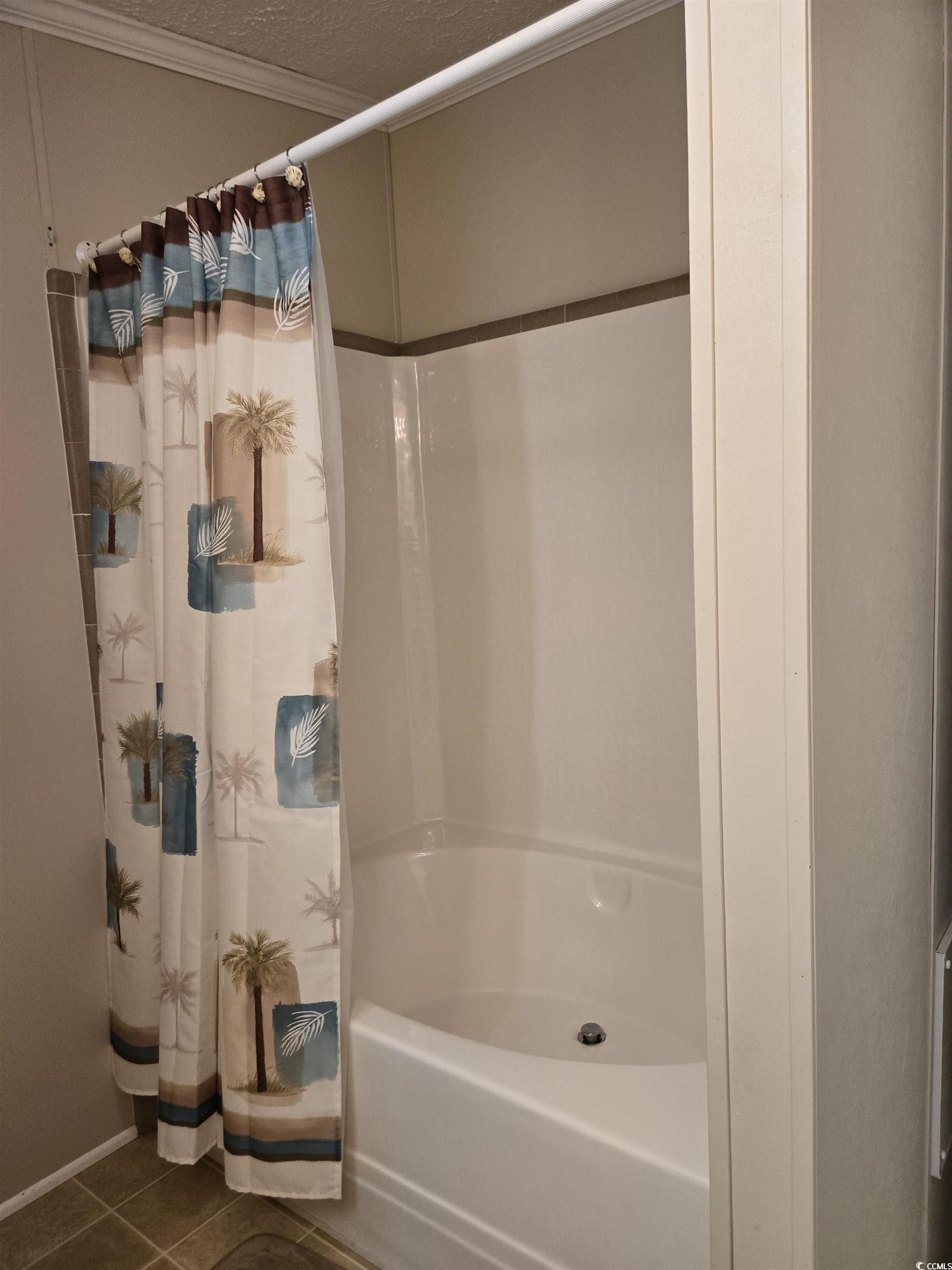 337 Clam Shell Circle Murrells Inlet, SC 29576 - Photo 27 of 29 Full bath featuring tile patterned floors, shower / bath combo, crown molding, and a textured ceiling