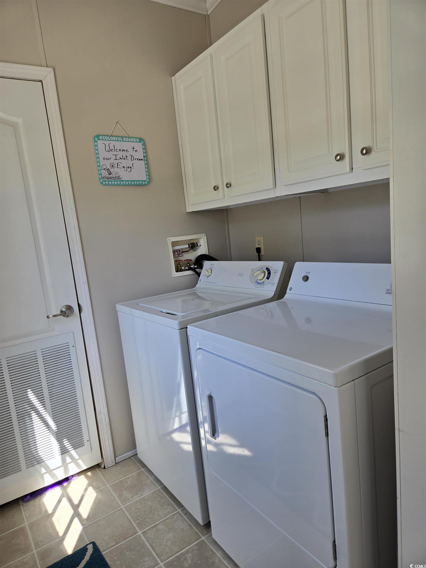 337 Clam Shell Circle Murrells Inlet, SC 29576 - Photo 29 of 29 Laundry area with washer and clothes dryer, cabinet space, and light tile patterned flooring
