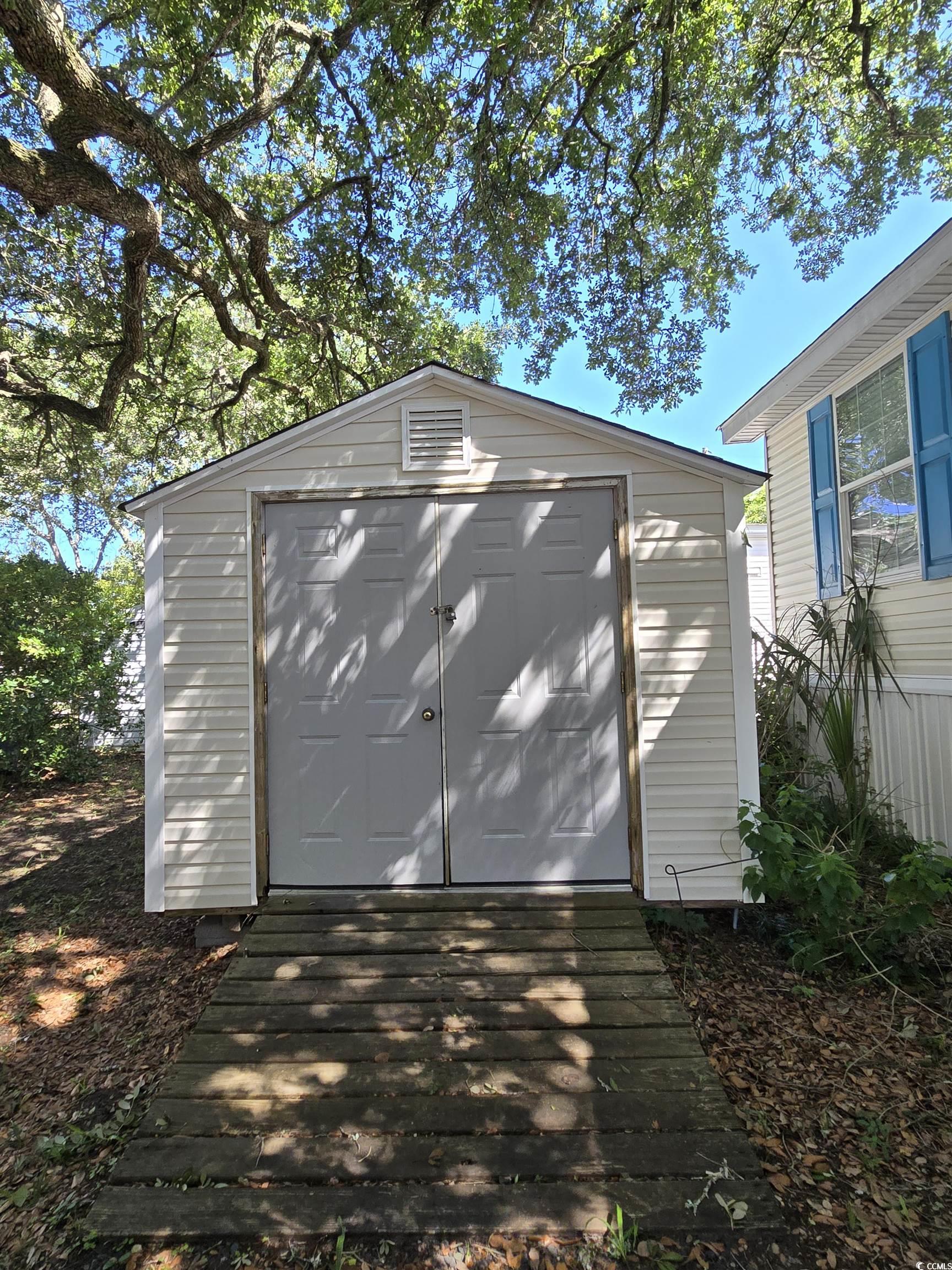 337 Clam Shell Circle Murrells Inlet, SC 29576 - Photo 6 of 29 Garage featuring a storage unit