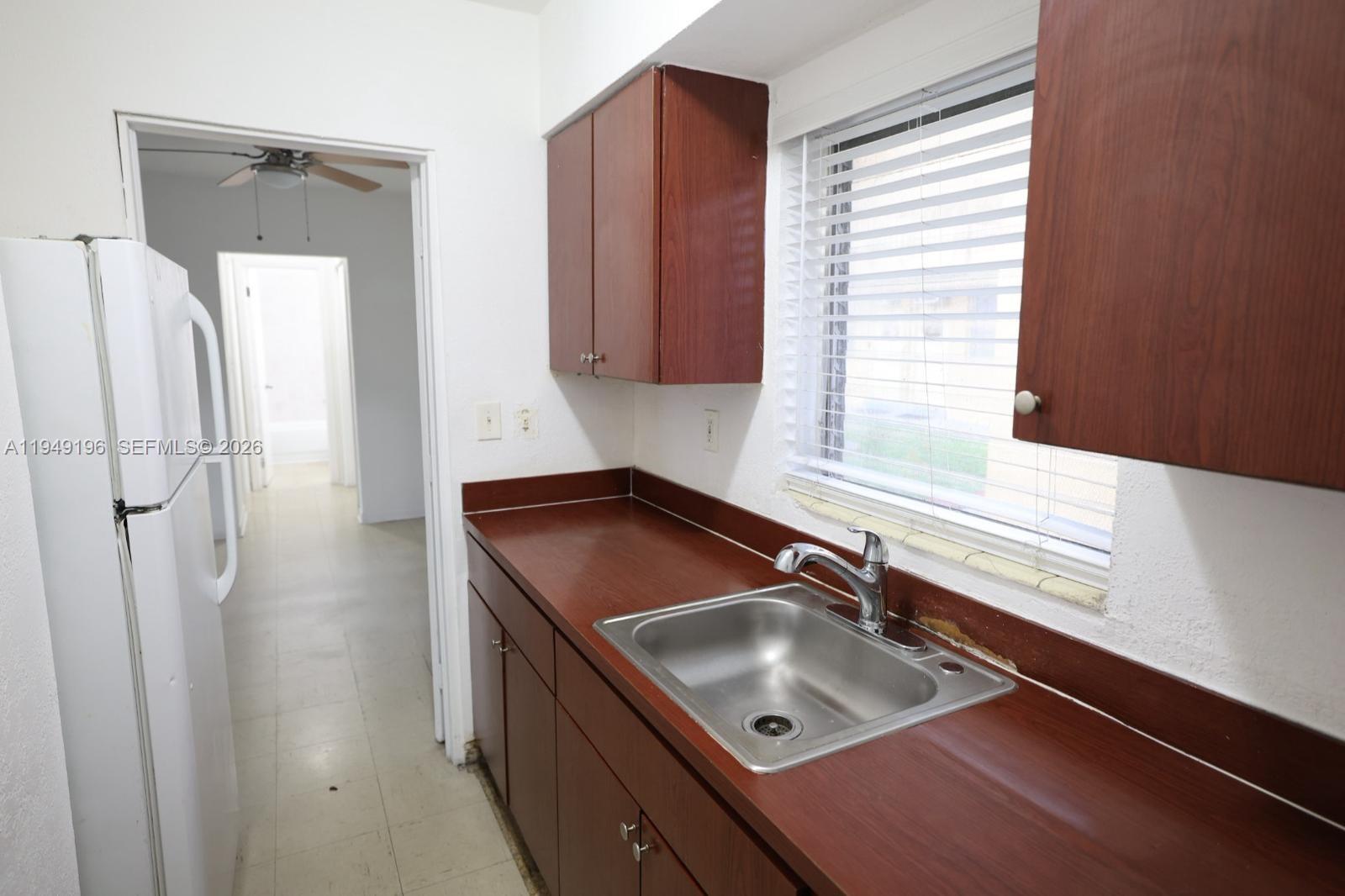 a kitchen with a sink a counter top space and cabinets