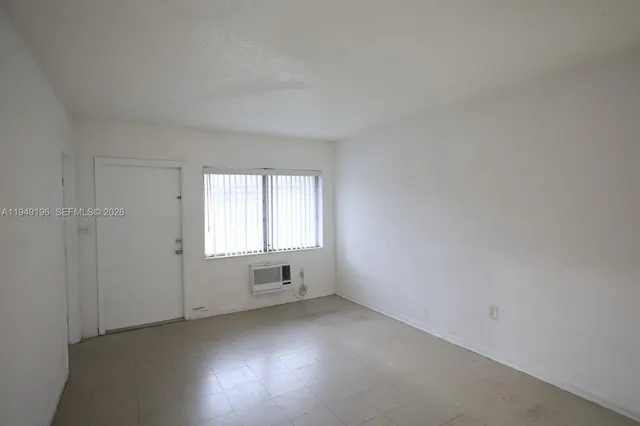an empty room with a windows and closet