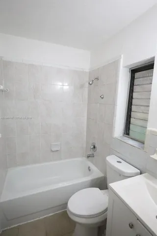 a bathroom with a toilet a sink and bathtub