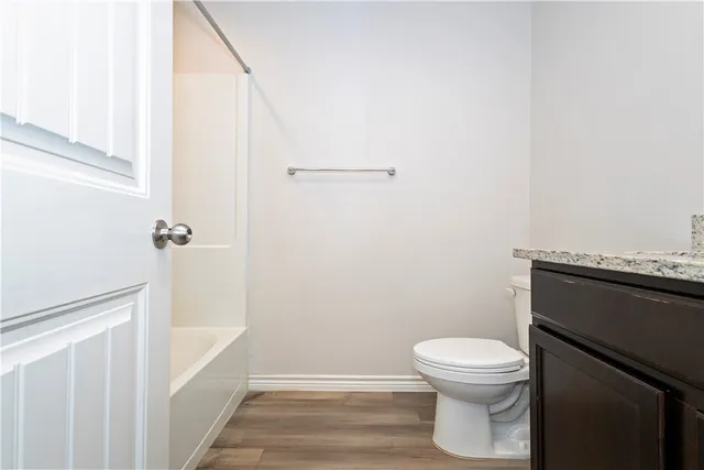 a white toilet sitting next to a shower