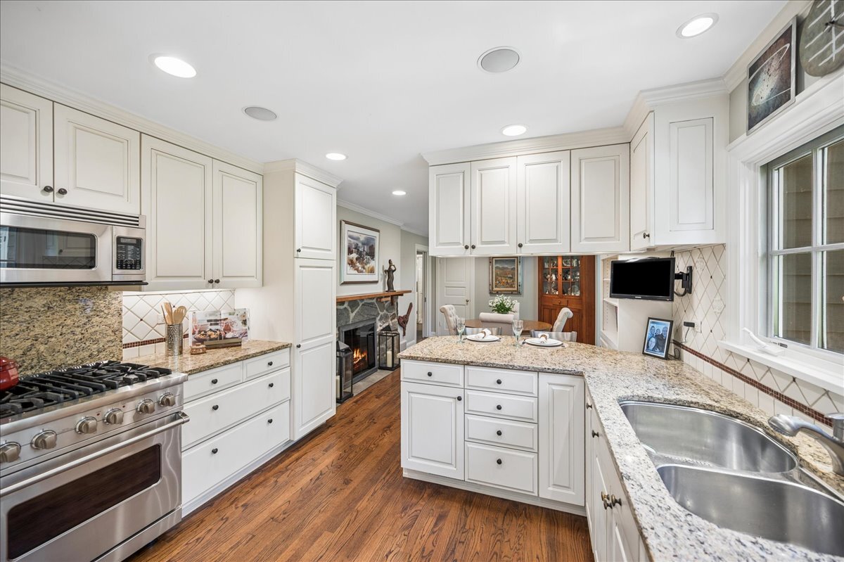 253 Summerfield Road Northbrook, IL 60062 - Photo 15 of 46 a kitchen with stainless steel appliances kitchen island granite countertop a stove and a sink