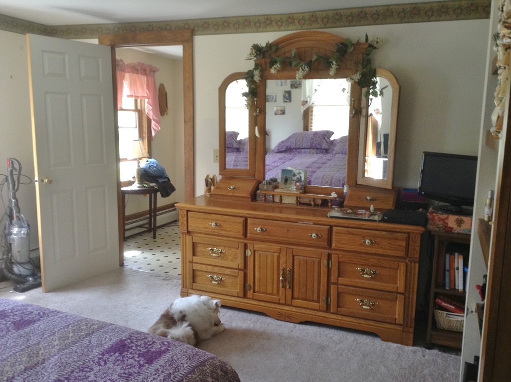 69 East Main Street Rindge, NH 03461 - Photo 18 of 27 a bedroom with a bed and a mirror on dresser