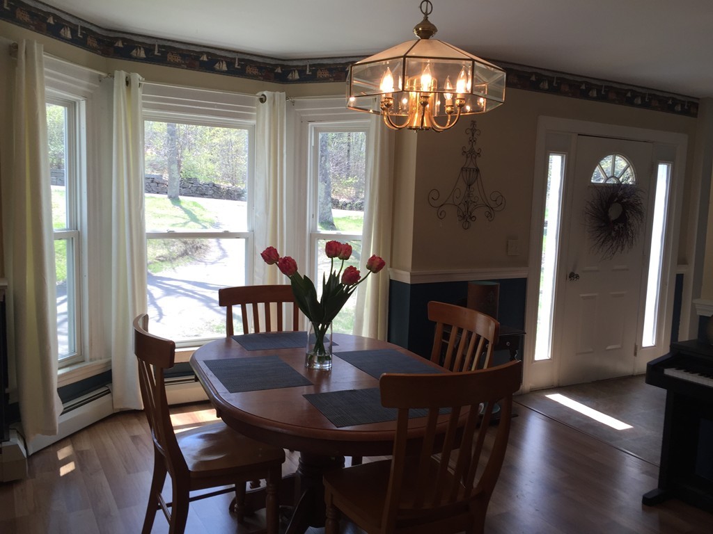 69 East Main Street Rindge, NH 03461 - Photo 2 of 27 a view of a dining room with furniture a chandelier and wooden floor