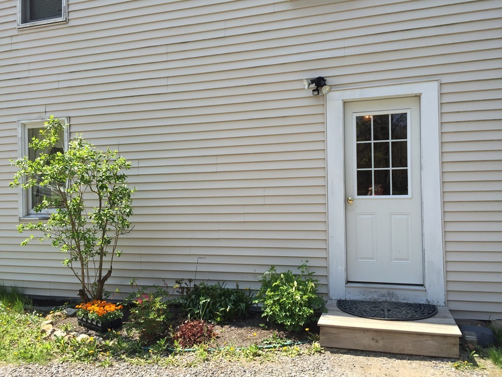 69 East Main Street Rindge, NH 03461 - Photo 21 of 27 a front view of a house with a garden