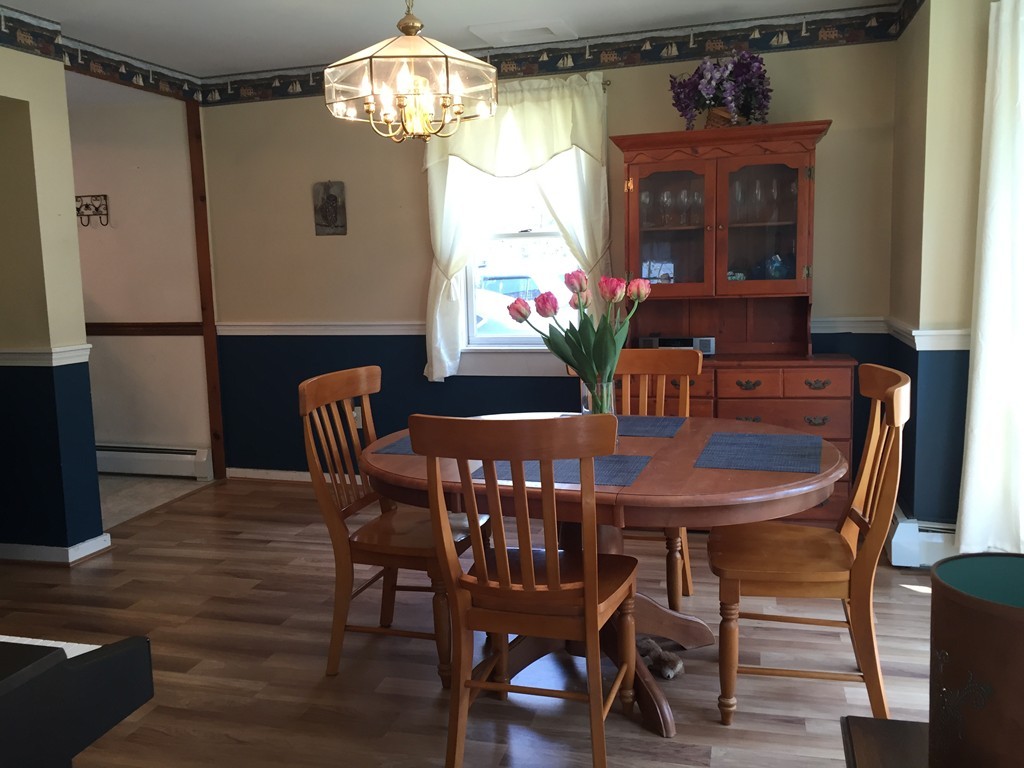 69 East Main Street Rindge, NH 03461 - Photo 3 of 27 a view of a dining room with furniture and chandelier