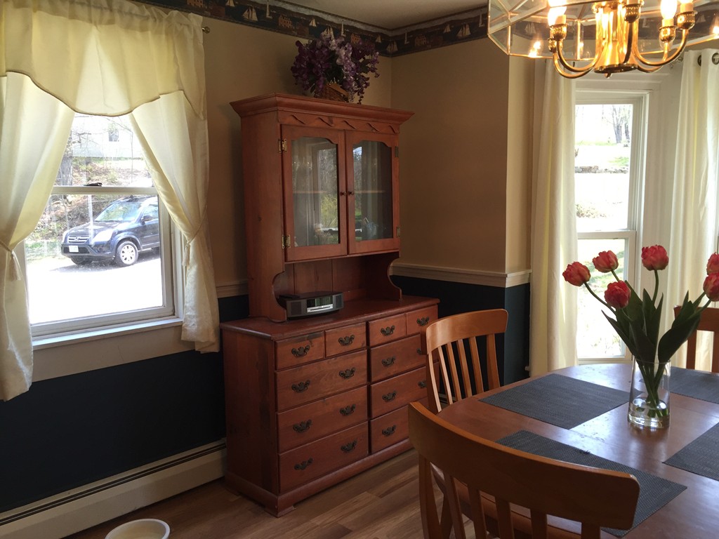 69 East Main Street Rindge, NH 03461 - Photo 4 of 27 a living room with furniture and a potted plant