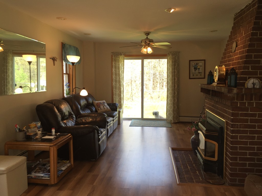 69 East Main Street Rindge, NH 03461 - Photo 6 of 27 a living room with furniture and a fireplace