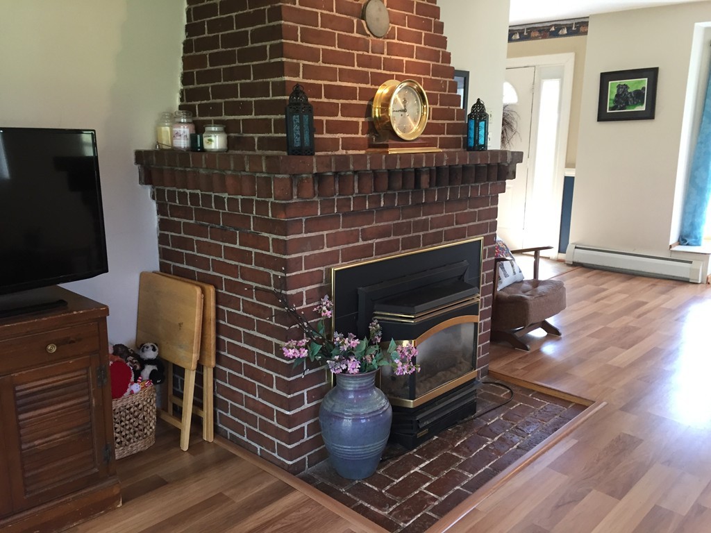 69 East Main Street Rindge, NH 03461 - Photo 7 of 27 a living room with furniture and a fireplace