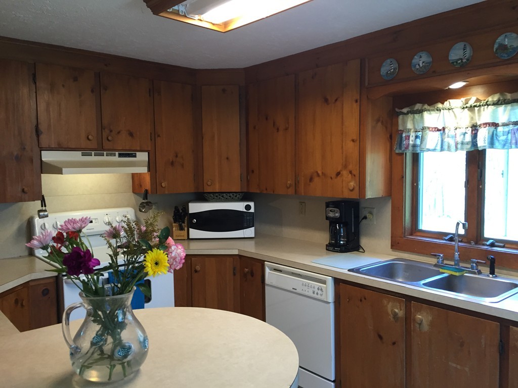 69 East Main Street Rindge, NH 03461 - Photo 9 of 27 a kitchen with a sink a stove and cabinets
