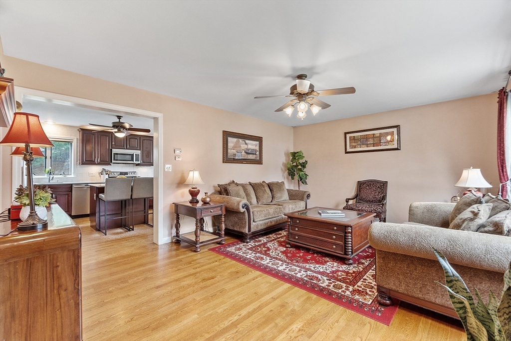 9 Robbins Road Ayer, MA 01432 - Photo 8 of 40 a living room with furniture a fireplace and a flat screen tv