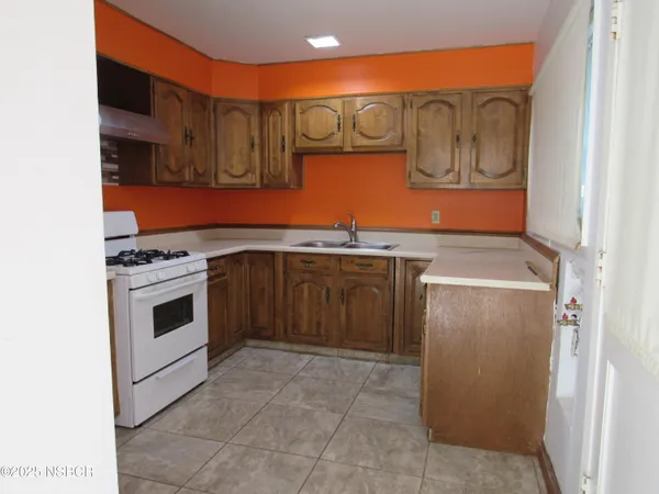 a kitchen with stainless steel appliances granite countertop a stove top oven