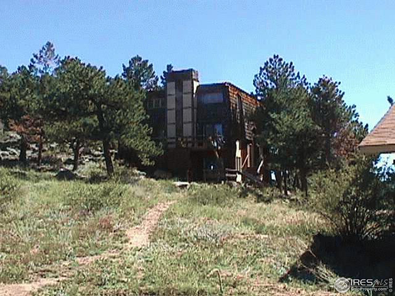 3982 Ridge Road Nederland, CO 80466 - Photo 1 of 3 a green field with trees in the background