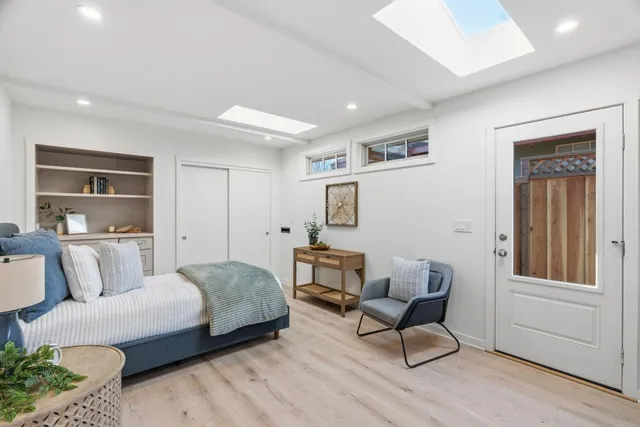 a bedroom with a bed and a couch