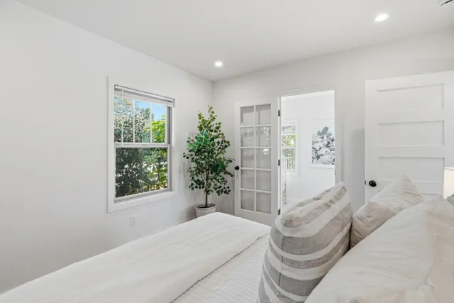 a view of a patio with table and chairs with wooden floor and fence
