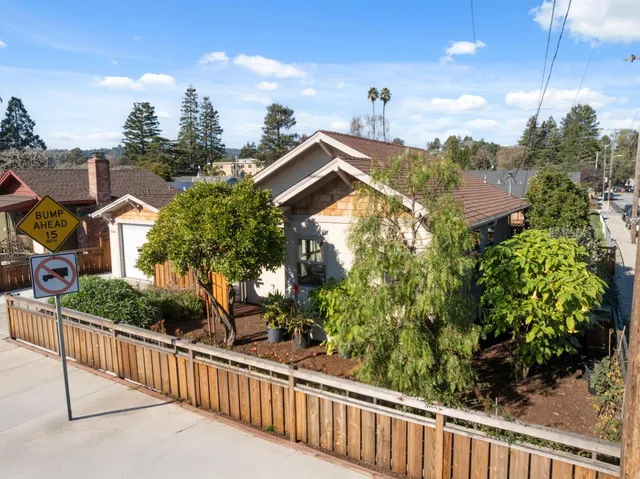 an aerial view of residential house with parking and mountain view