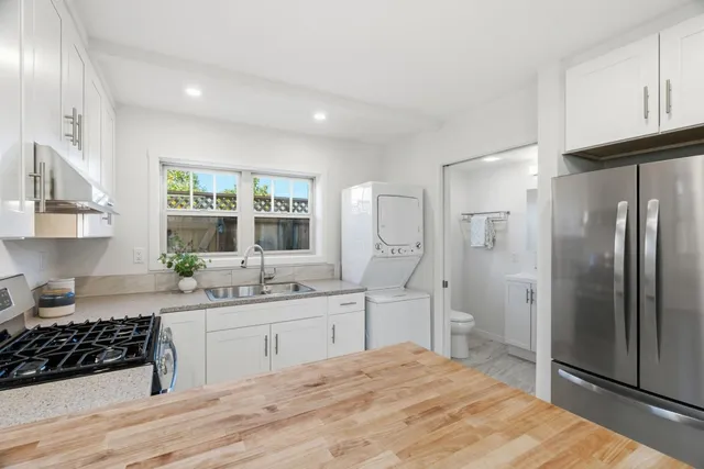 a view of a livingroom with furniture wooden floor and windows