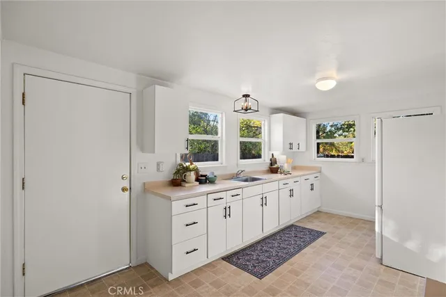 a kitchen with sink and cabinets