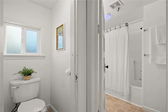 a bathroom with a toilet a sink and shower