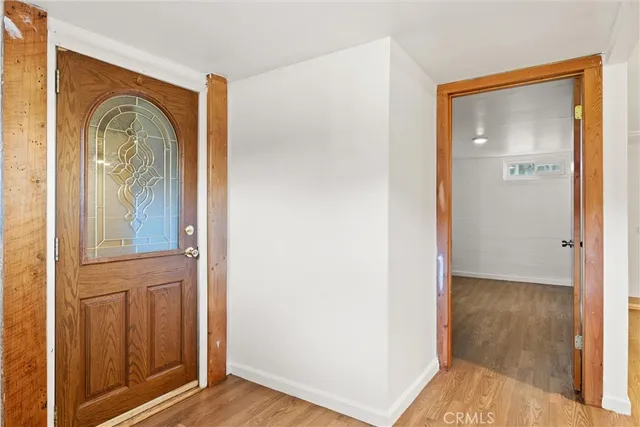 a view of front door with wooden floor