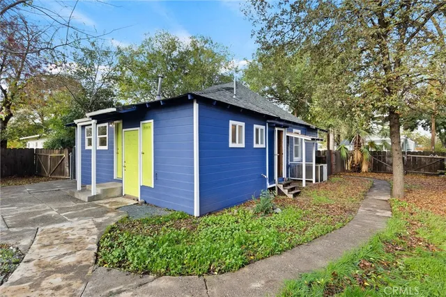 a front view of a house with a garden