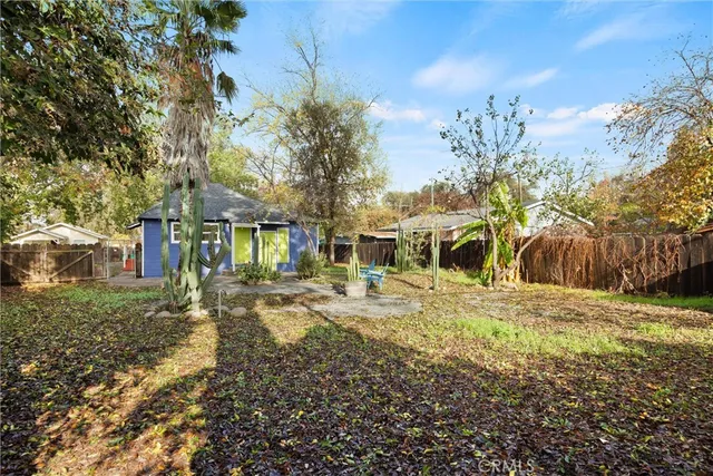 a view of a house with a yard and sitting area