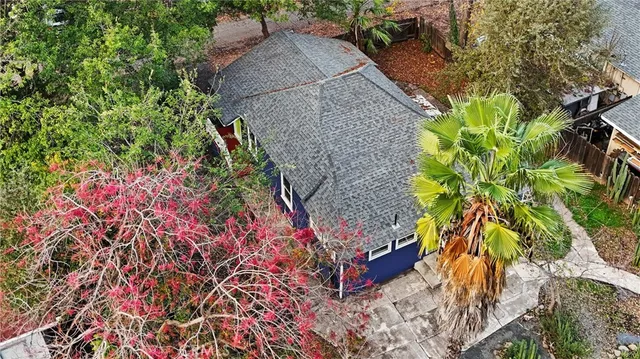 an aerial view of a house with a yard
