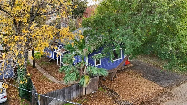 an aerial view of a house with a yard and trees
