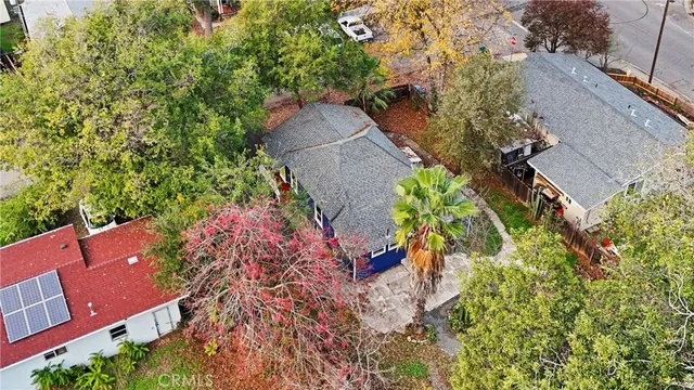 an aerial view of a house with a yard and trees