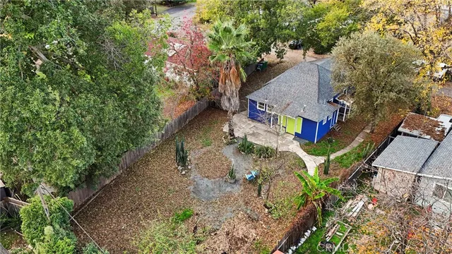 a view of wooden house with a small yard
