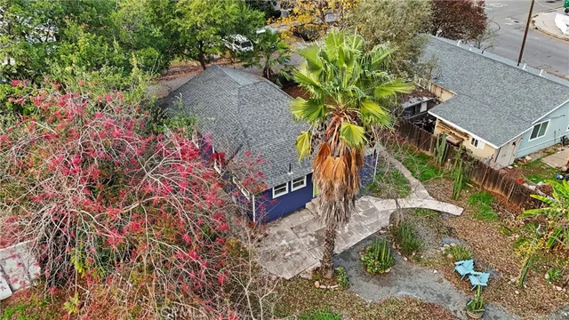 a view of wooden house with a small yard