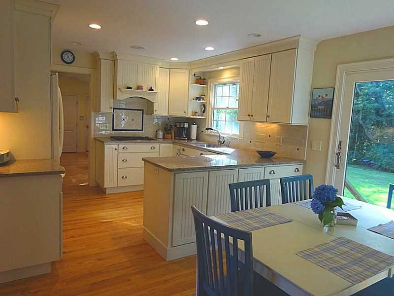 48 Pleasant Street Portsmouth, RI 02871 - Photo 11 of 25 Dining Room. U shaped kitchen design has custom cabinets with pull out shelving, granite counters, oversized stainless sink, instant hotwater dispenser, tile backsplash, Wolf gas range, Bosch Dishwasher,compactor, bottom freezer refrigerator and under-mount lightening