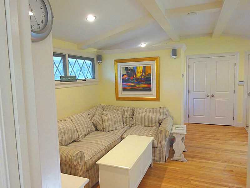 48 Pleasant Street Portsmouth, RI 02871 - Photo 12 of 25 Den/Family/Great Room. The family room is a step down from the kitchen. The coffered ceilings here are also cathedral and add a spacious element.The diamond paned windows to the left are original features of the home. All interior and closet doors have been replaced