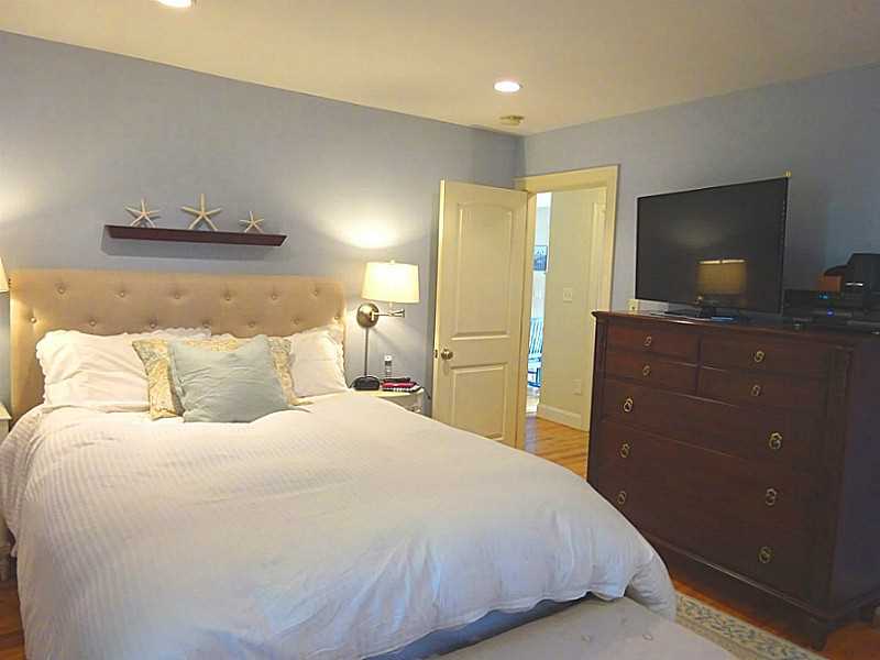 48 Pleasant Street Portsmouth, RI 02871 - Photo 16 of 25 Master Bedroom. The master bedroom suite is on the first floor.Originally 2 smaller bedrooms, this space now includes a spa bath with a walk in closet and built in shelving.