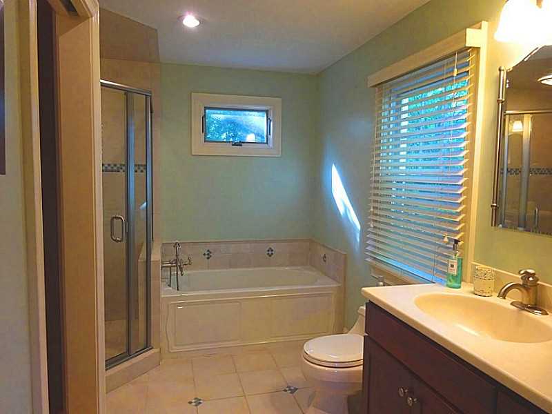 48 Pleasant Street Portsmouth, RI 02871 - Photo 18 of 25 Master Bath/Spa. This spacious bath features radiant flooring, soaking tub,separate glass enclosed shower with bench and Grohe showerhead, Corian countertop/sink,Kohler and brushed nickel faucets