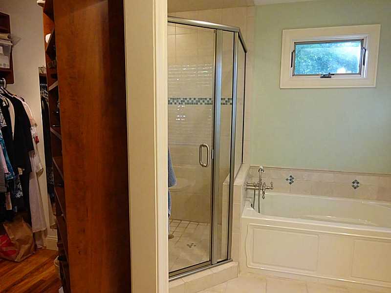 48 Pleasant Street Portsmouth, RI 02871 - Photo 19 of 25 Master Bath/Spa. Cherry cabinets and custom closet includes a built in ironing board too! All of the hardware and faucets in the home are brushed nickel