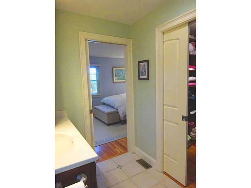 48 Pleasant Street Portsmouth, RI 02871 - Photo 20 of 25 Master Bath/Spa. This is a view of the master bath with the closet to the right. The pocket door is easy to use and doesn t take up floorspace. The lightening works off of a sensor, no need to find the switch.