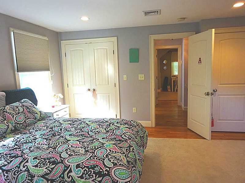 48 Pleasant Street Portsmouth, RI 02871 - Photo 23 of 25 Bedroom. A view of the bedroom to the hallway with the full bath to the left and the second upstairs bedroom straight ahead.