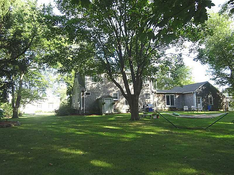 48 Pleasant Street Portsmouth, RI 02871 - Photo 5 of 25 Exterior Back. The house is situated on the lot to take advantage of a spacious back yard with plenty of room for gardens, hammocks and swing sets perhaps even a pool