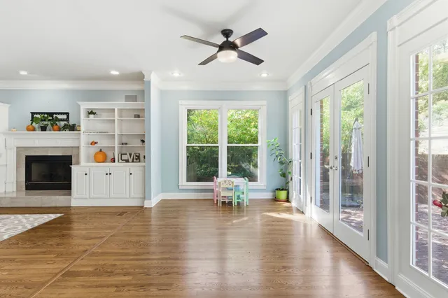 a living room with furniture large window and a fireplace